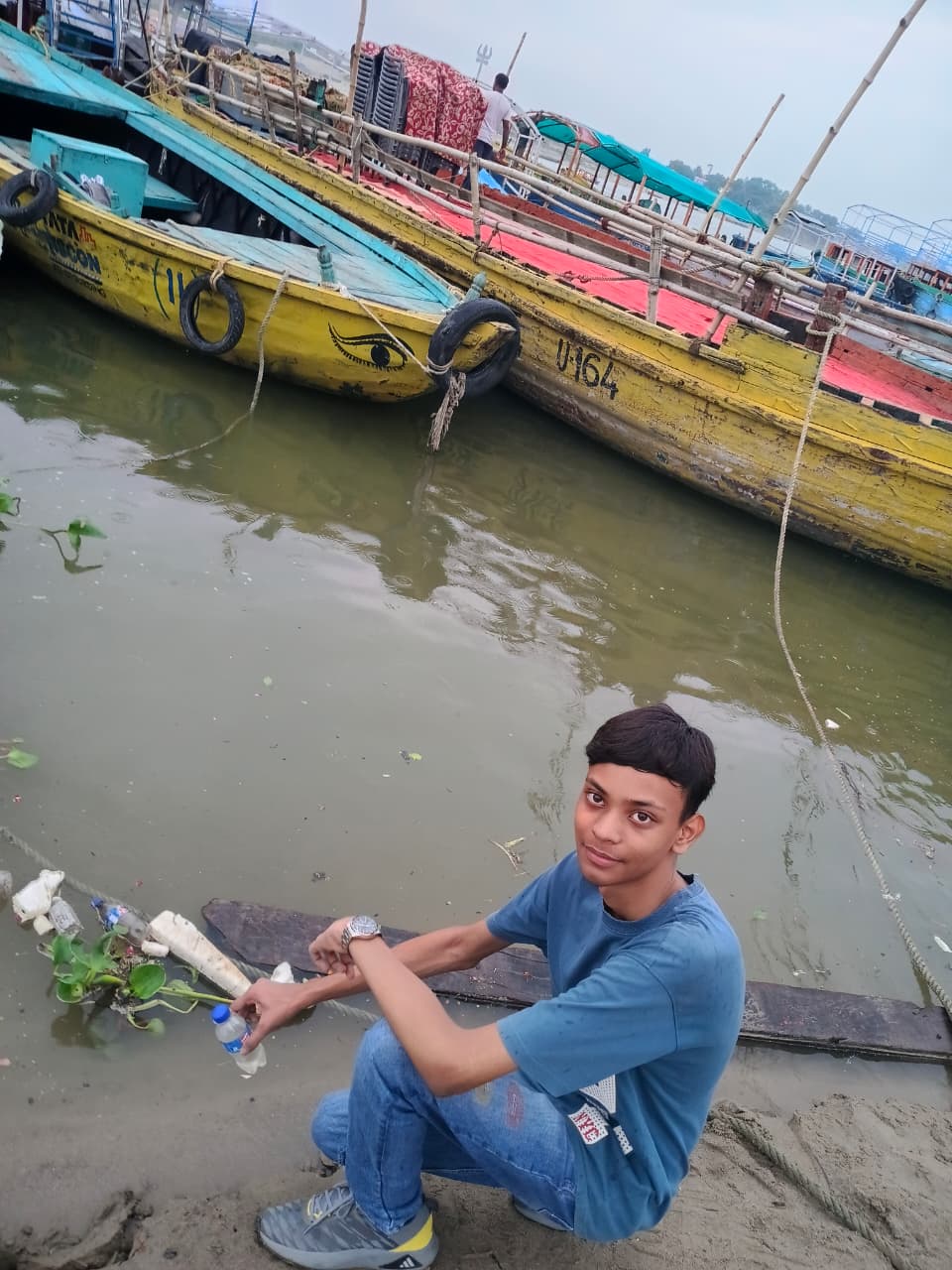 Rishi sampling contaminated river water at the ghat